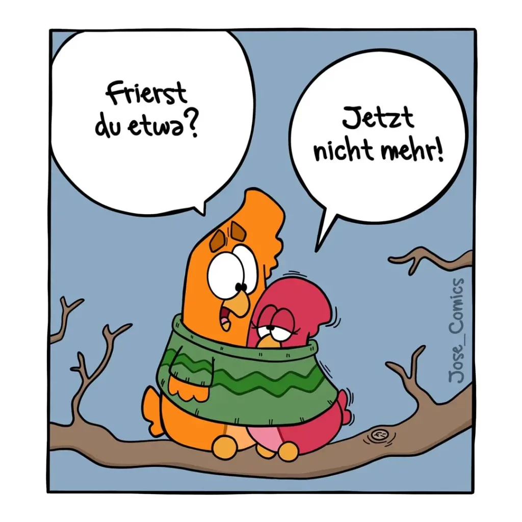 Zwei bunte Vögel sitzen eng zusammen in einem grünen Nest auf einem Ast. Der orange Vogel fragt «Frierst du etwas?», der rote antwortet «Jetzt nicht mehr!»